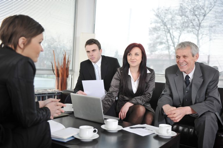 businesswoman in an interview with three business people getting positive feedback SKWzSUA4i