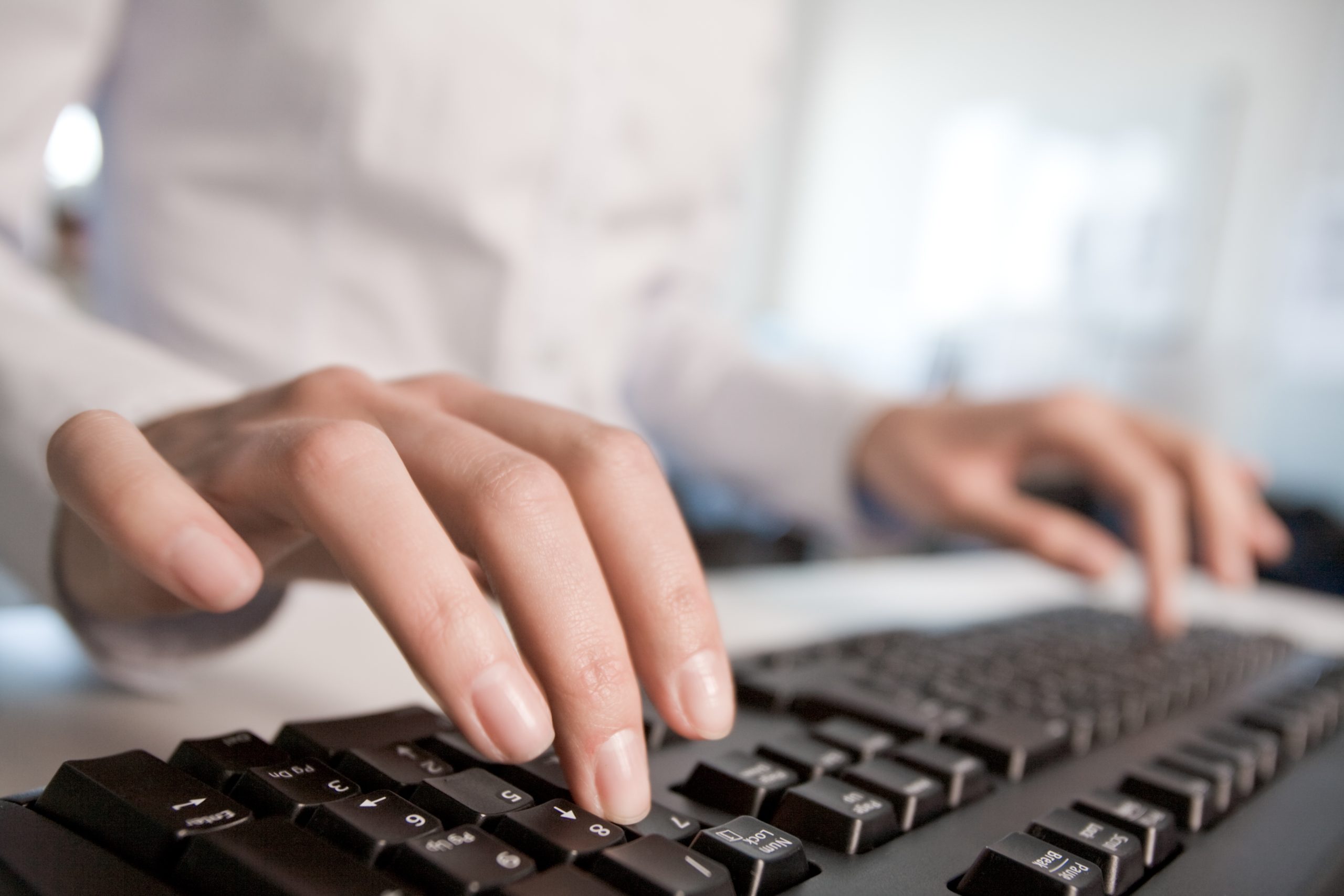 graphicstock image of female hands pressing computer keys at workplace BqbGgyRwNb scaled