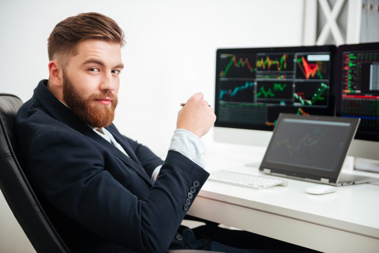 graphicstock portrait of confident young businessman sitting and working in office BLRnBd7ung