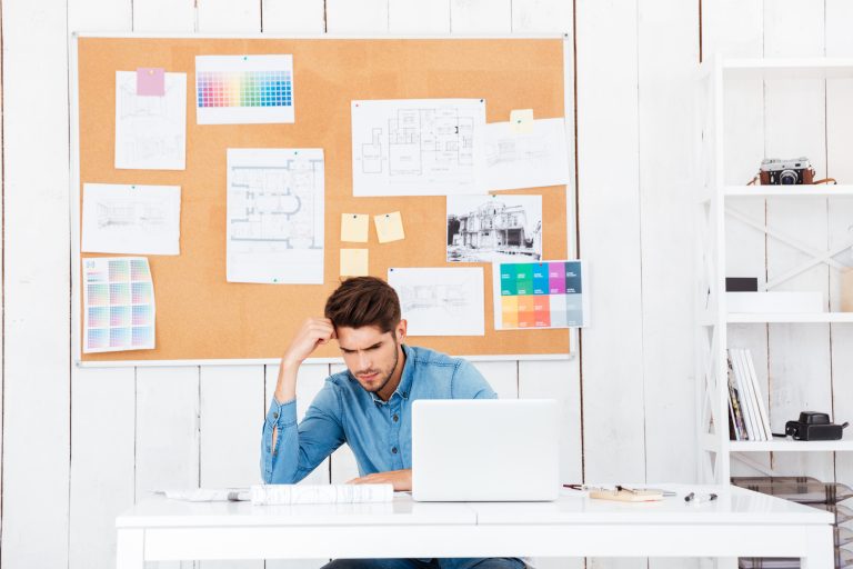 graphicstock young tired businessman sitting with laptop at the desk in office BuQPO6qBhx