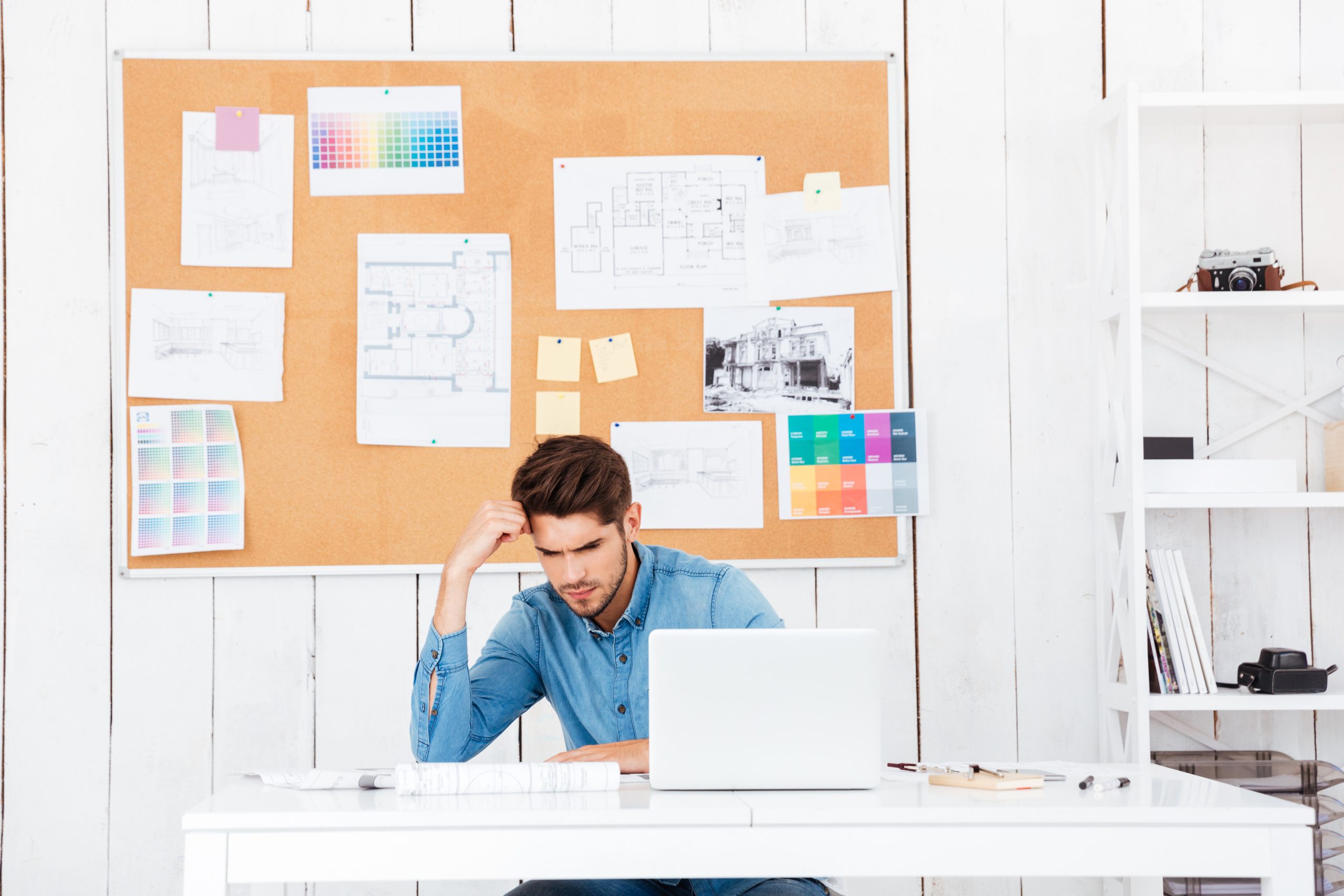 graphicstock young tired businessman sitting with laptop at the desk in office BuQPO6qBhx scaled